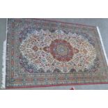 Machine woven Persian design carpet with a medallion and floral design on ivory ground, 10ft x 7ft