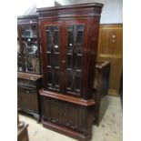 Reproduction mahogany standing corner cabinet with a pair of bevelled bar glazed doors above a