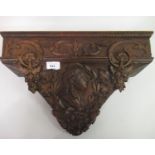 19th Century carved mahogany clock bracket relief decorated with floral garlands and a profile