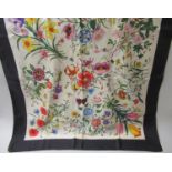 Two Gucci V. Accornero, floral silk scarves with black borders, each 34ins x 34ins Both having