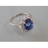 18ct White gold oval cornflower sapphire and diamond cluster ring, the sapphire approximately 2.94ct