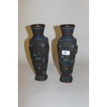 Pair of 20th Century Chinese dark patinated bronze two handled baluster form vases decorated in