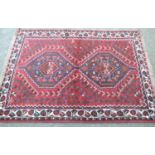 Small Shiraz rug with a twin pole medallion design on red ground with borders, 5ft x 3ft 8ins