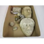 Two small antique limestone mask heads, fossilised sea urchin and other stone relics etc The two