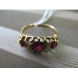 18ct gold ring set three rubies and four small diamonds