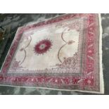 Large Sparta carpet with a pink medallion and swag design on an ivory ground with borders, 15ft 6ins