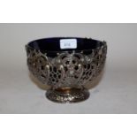 Late 19th Century silver pedestal bowl with floral embossed and pierced decoration and a blue