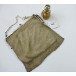 Silver chain mesh evening purse together with a silver mounted cut glass smelling salts bottle