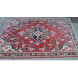 Saruq rug with centre medallion and floral design on rose ground with borders, 6ft 8ins x 4ft 6ins