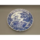 20th Century Japanese circular blue and white charger decorated with figures in a sailing boat in