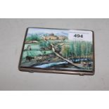 Middle Eastern white metal and enamel cigarette case, the lid decorated with an extensive landscape,
