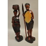 Pair of modern African carved hardwood figures of tribes people, the tallest 35ins