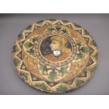 Large Continental terracotta wall plate incised with a portrait within floral borders