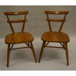 Pair of mid 20th Century Ercol Red Dot children's elm chairs