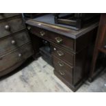 Reproduction mahogany twin pedestal desk, the leather inset top above nine drawers with brass