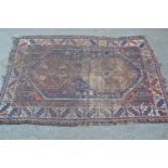 Small Belouch rug with twin medallion design, 5ft x 3ft 6ins approximately (worn)