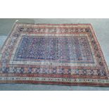 Shirvan rug with blue ground repeating rosette centre panel and multiple borders (various areas of