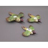 Graduated set of three Beswick wall plaques, each in the form of a green woodpecker, 7ins, 6ins