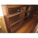 Pair of oak Globe Wernicke three section bookcases with bevelled glass doors above ogee fronted