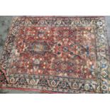 Antique Mahal carpet with an all-over stylised floral design on a brick red ground with borders,