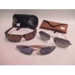 Two pairs of Ray-Ban sunglasses in original cases, together with another uncased pair of Ray-Ban