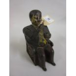 19th Century painted cast iron ' Tammany ' money bank in the form of a seated gentleman wearing a