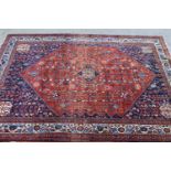 Abadeh rug with all-over floral design and multiple borders on a wine ground, 81ins x 61ins