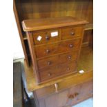 Table top oak chest of two short over three long graduated drawers with knob handles and plinth