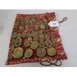 Bag containing a quantity of various cast bronze jewellery / badge dies, some marked P. Croy