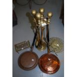 Brass fireside set on stand (lacking poker), two brass trivits and two copper warming pans with