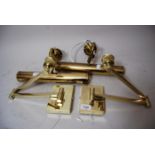 Pair of modern gilt brass articulated wall lights together with a pair of similar picture lights