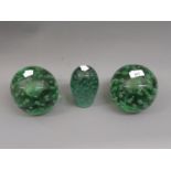 Pair of large Victorian green bubble glass dump weights, together with another similar