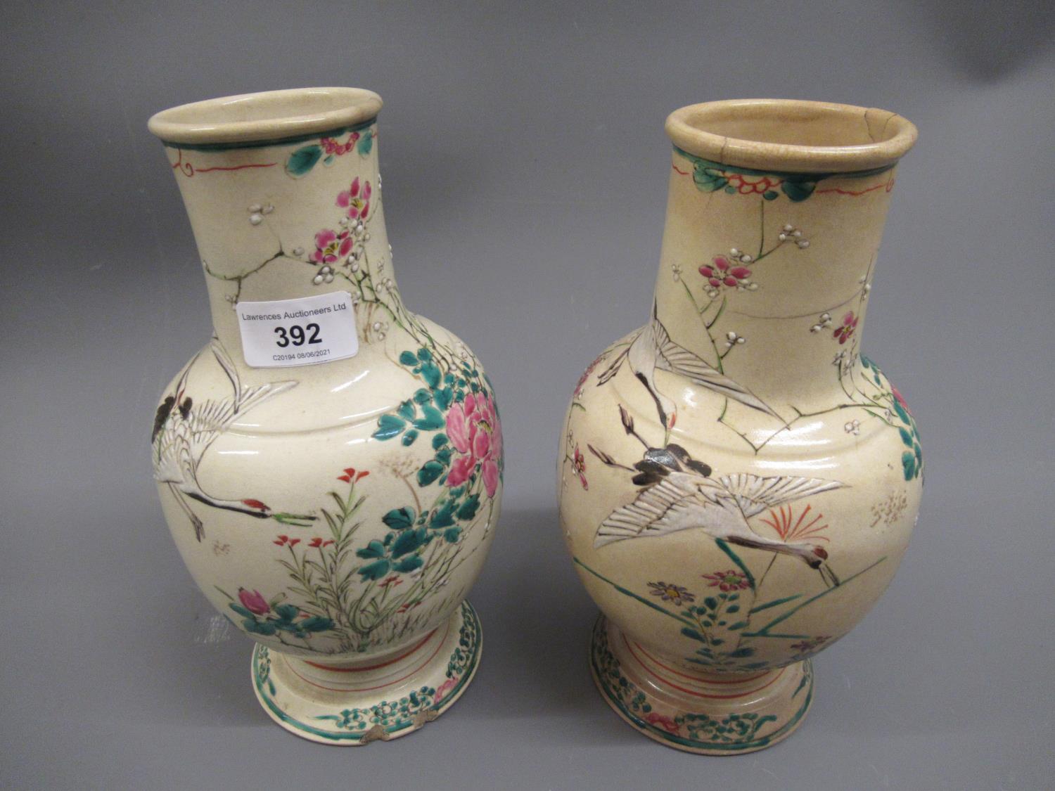 Pair of Japanese Satsuma pottery baluster form vases painted with birds in landscapes (at fault),