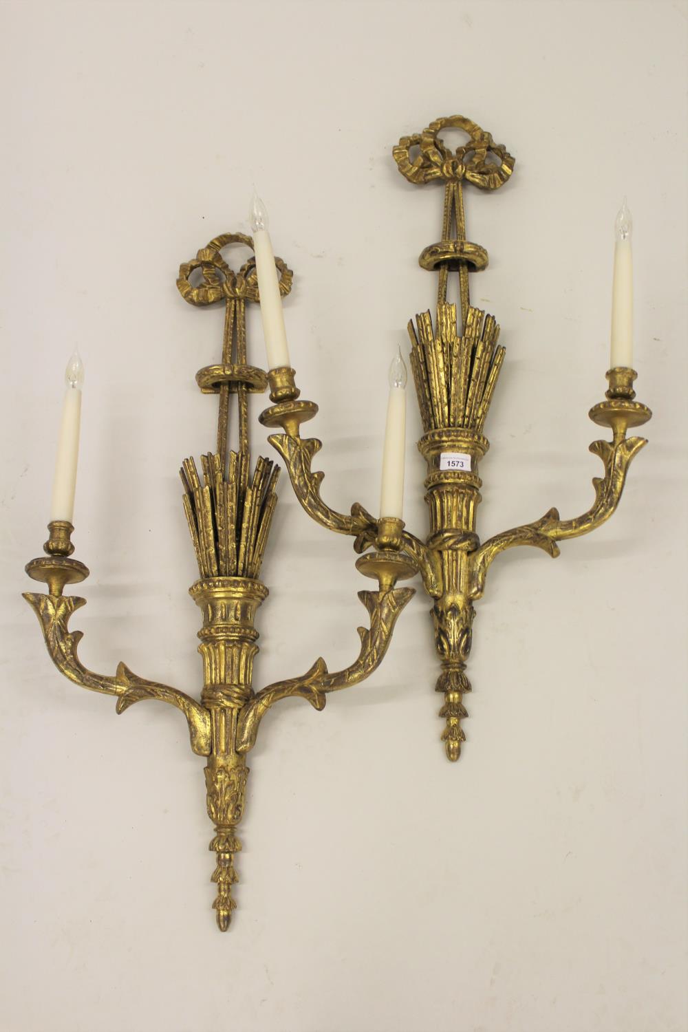 Pair of 19th Century carved and gilded twin light wall sconces, each with a bow surmount above a