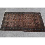 Small Kurdish rug with an all-over stylised floral design on a brick red ground with borders, 4ft