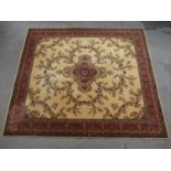 Wilton type machine woven carpet with a medallion and floral design on a beige ground with