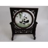 Modern Chinese carved hardwood and needlework table screen, the centre panel worked with a study
