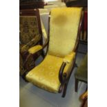Victorian mahogany and upholstered elbow chair with scroll arms, raised on splay supports