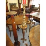 Late 20th Century Dutch style gilt candle stand and a circular oak torchere with turned column