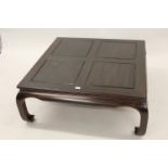 Large Chinese square hardwood coffee table on shaped moulded supports, 42ins square