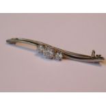Three stone diamond set bar brooch, approximately 1.15ct total, 52mm wide, 3.6g The centre stone