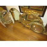 19th Century oval wall mirror the frame embellished with roses and flowers, 16ins high, similar