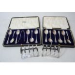 Pair of Sheffield silver four division toast racks, cased set of six silver coffee spoons and a