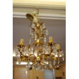 Christopher Wray gilt metal and crystal glass five light electrolier of scroll and foliate design,