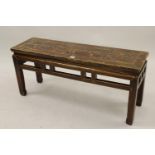 Early 20th Century Chinese elm bench seat with a pierced frieze raised on square moulded supports