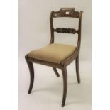 Set of six Regency rosewood carved rail back dining chairs with drop-in seats raised on sabre