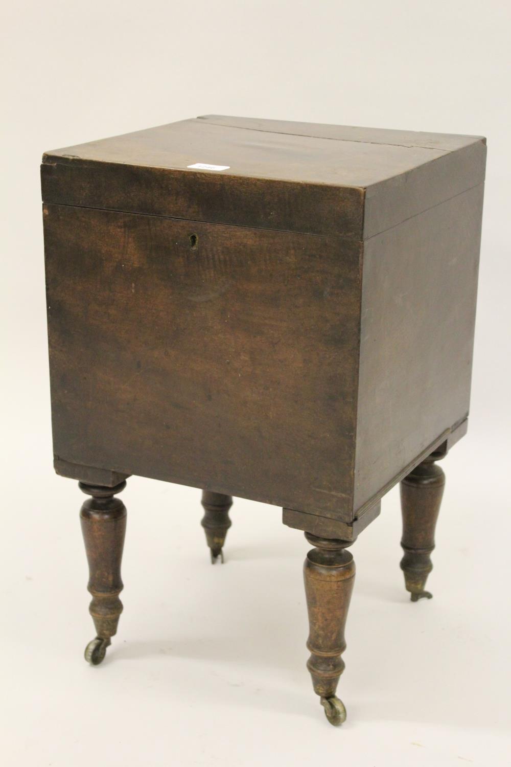 Early 19th Century square mahogany wine cellarette, the hinged cover enclosing a fitted interior