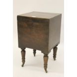 Early 19th Century square mahogany wine cellarette, the hinged cover enclosing a fitted interior