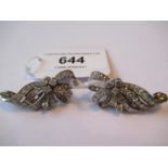 Pair of mid 20th Century platinum bow design ear clips set with brilliant and baguette cut diamonds,