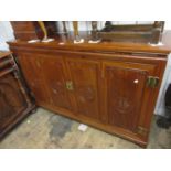 Mid 20th Century oriental hardwood four door side cabinet with brass hinges and handles, 60ins wide